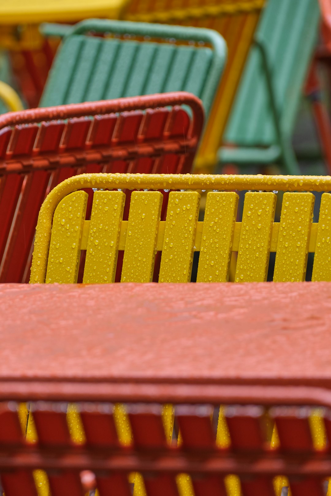 Colorful powder coated metal chairs on a patio