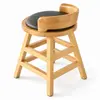 Three-quarter view of wooden dining stool with curved backrest and round padded seat