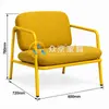 Side view of café armchair showing yellow tubular steel armrests and angled metal legs