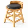 Close-up of gray leather upholstery and curved wooden backrest on restaurant stool