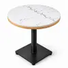 Close-up of white quartz tabletop with gray veining and rounded edge detailing
